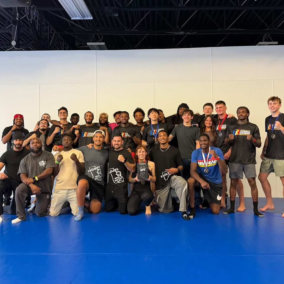 Faglier's teens and adults together on the mat with their tournament medals